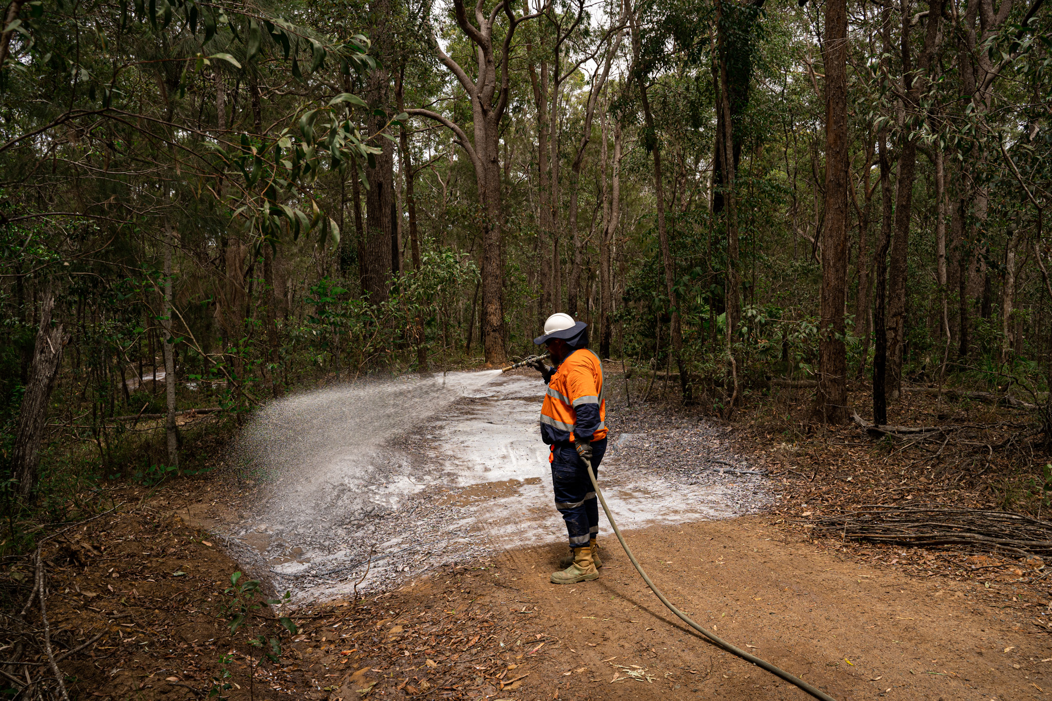 A Vital Chemical worker applying Vital Track Bind to an area.