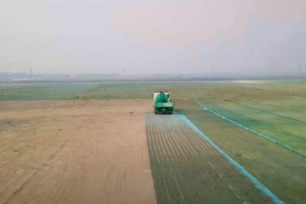 A truck applying chemicals to a field 