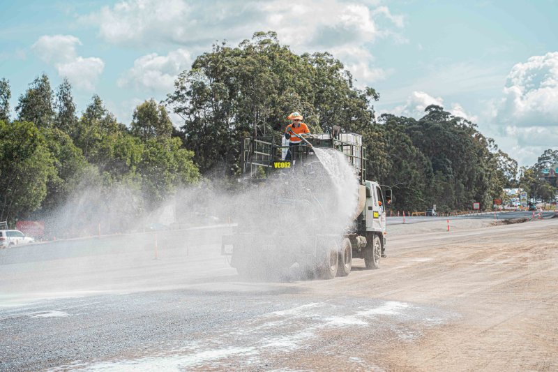 A Vital Chemical worker spraying Bon-Matt HR onto a road.