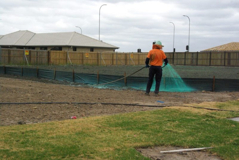 Vital Chemical employee applying chemicals to the ground