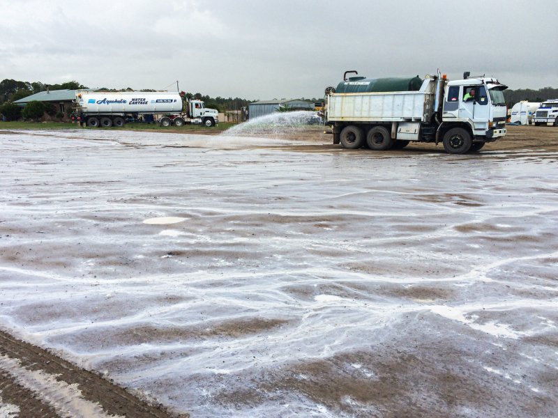 A Vital Chemical truck applying Bon-Matt HR to a dirt surface.