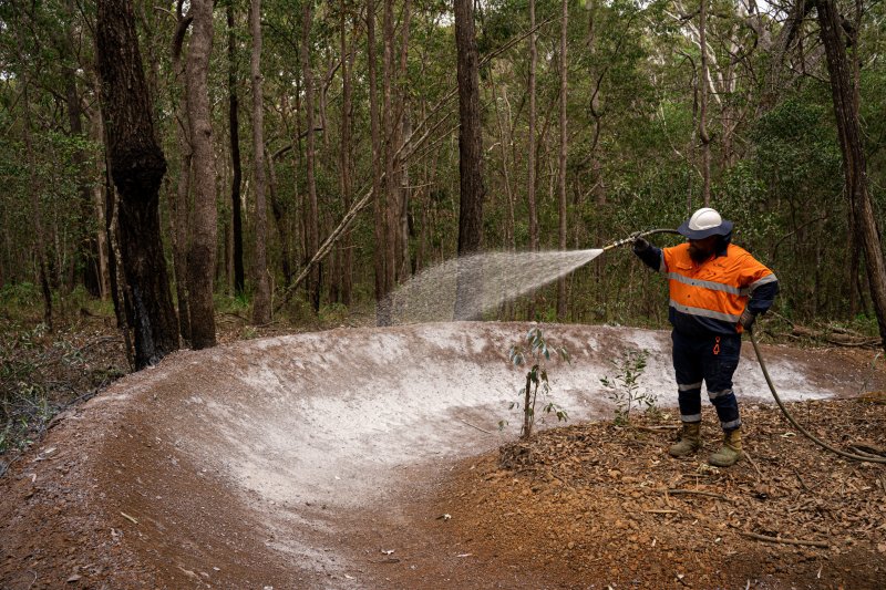 A Vital Chemical worker applying Vital Track Bind to an area.