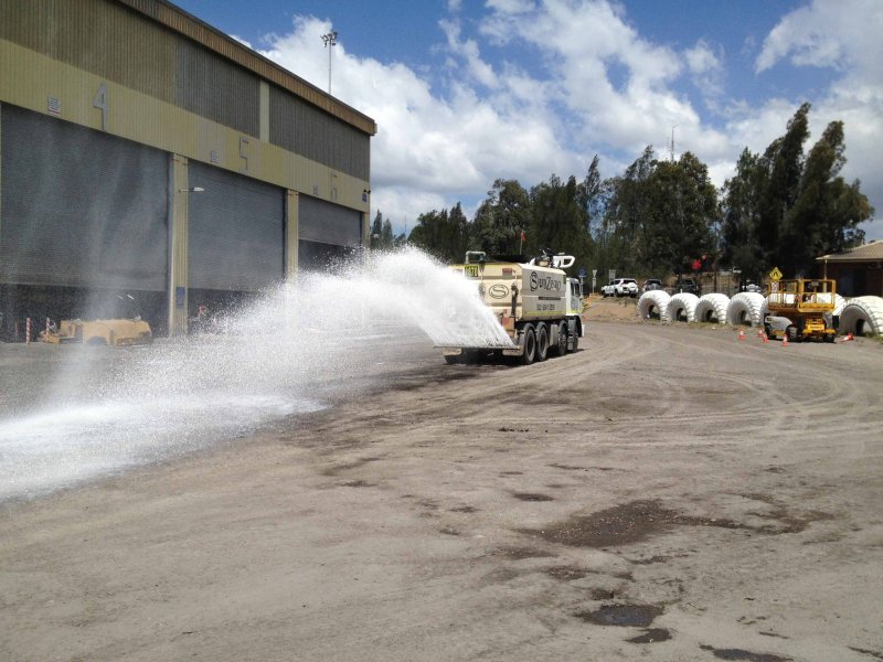 A Vital Chemical truck applying Bon-Matt HR onto a gravel surface.