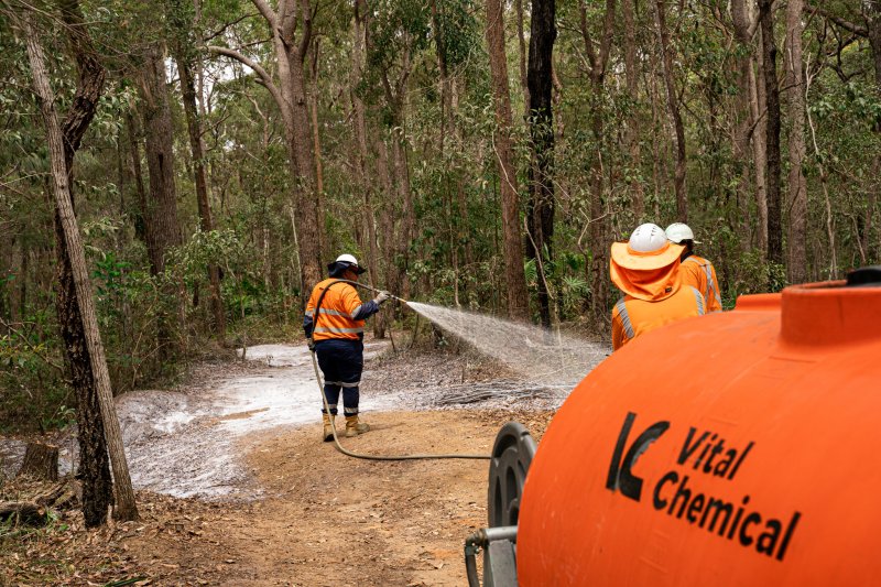 A Vital Chemical worker applying Vital Track Bind to an area.